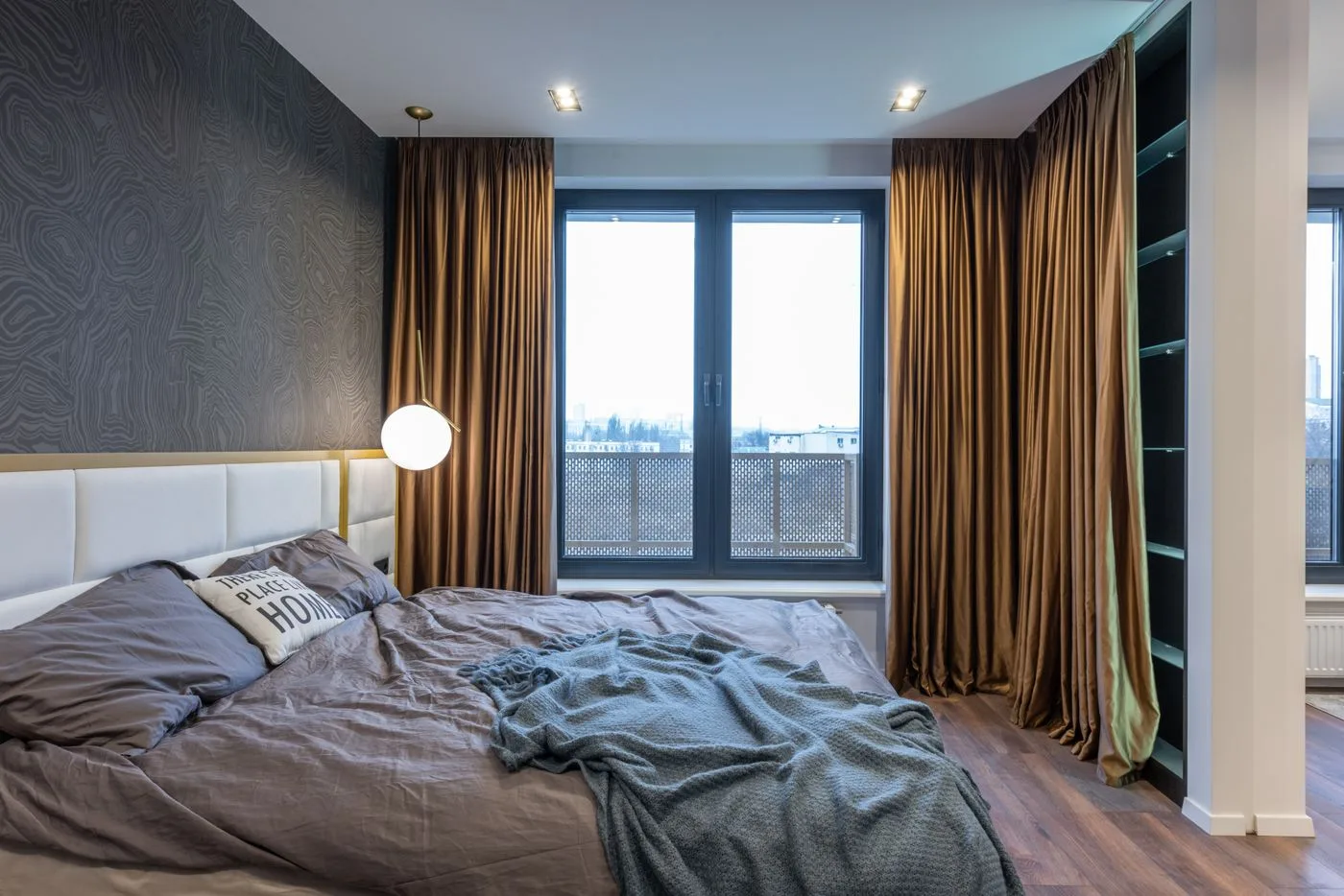 Modern bedroom interior with bed near window with curtains