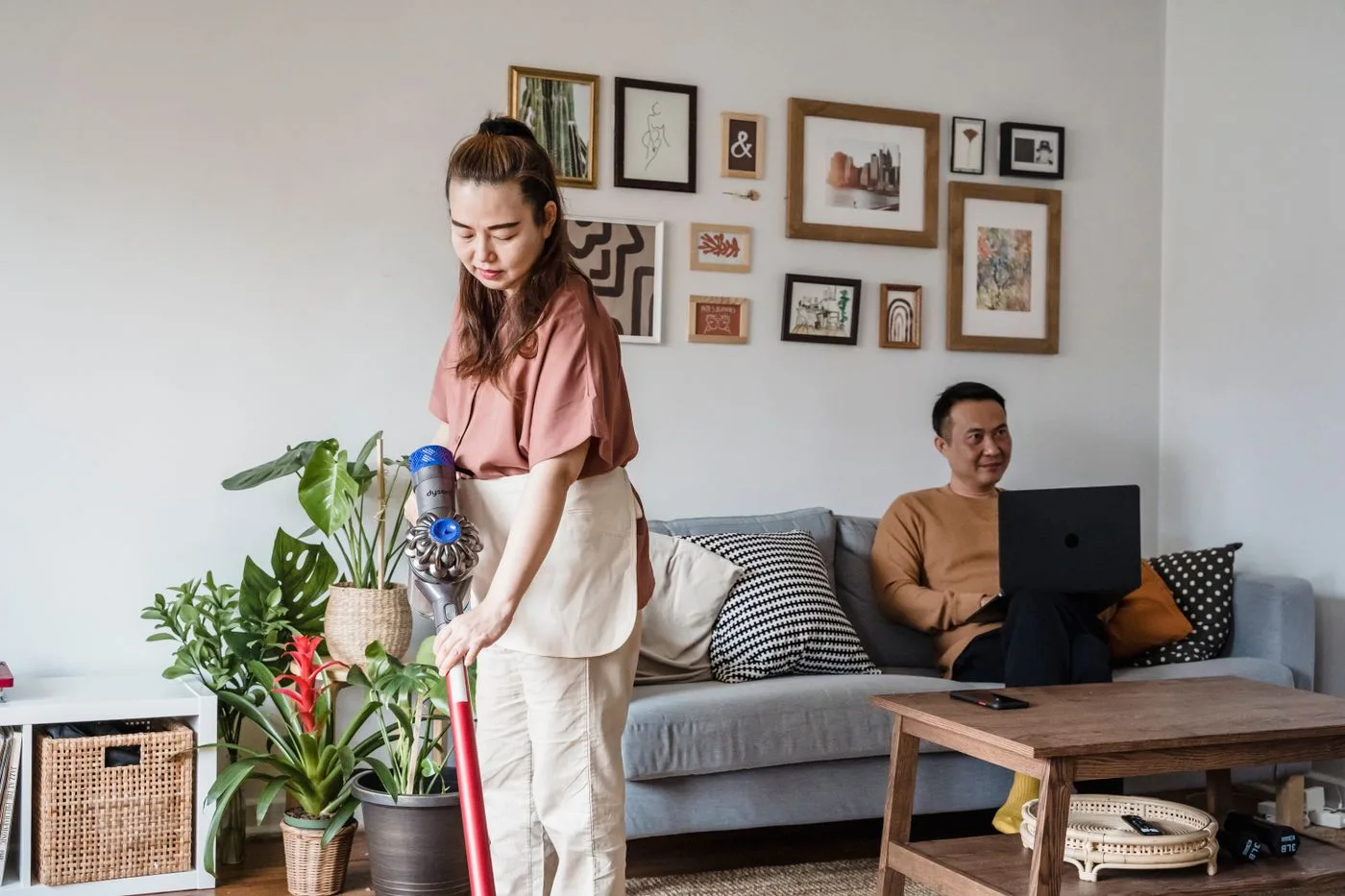 A Woman Vacuuming in a Living Room